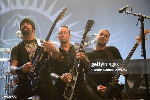 Rob Caggiano, Michael Poulsen and Anders Kjolholm of Volbeat perform on stage during Rock Allegiance Tour 2013 at US Cellular Coliseum on August 29,...