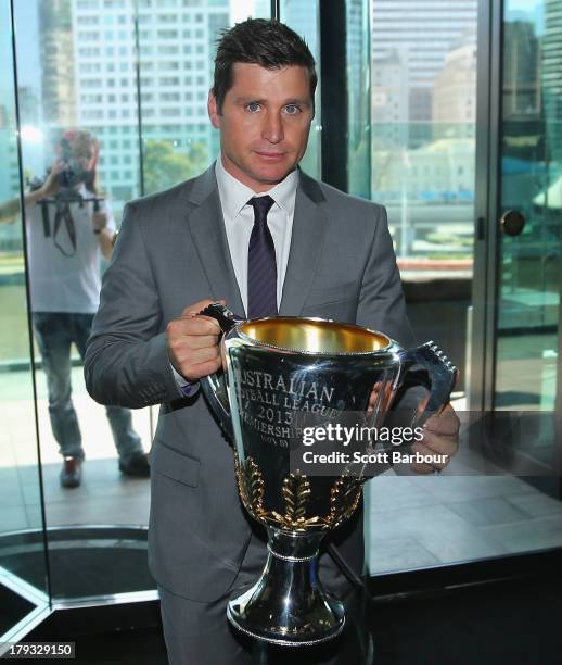 Former AFL player Shane Crawford holds the 2013 AFL Premiership Cup during the 2013 AFL Finals Series Launch at Club 23 on September 2, 2013 in...