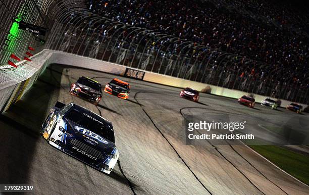 Brad Keselowski, driver of the Miller Lite Ford, leads a pack of cars during the NASCAR Sprint Cup Series AdvoCare 500 at Atlanta Motor Speedway on...