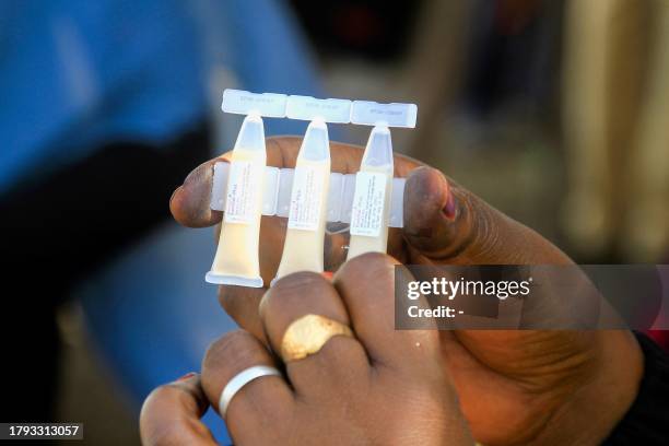 Nurse holds shows the cholera vaccine in Sudan's Gedaref city on November 20, during a vaccination campaign to reduce the cholera epidemic in...