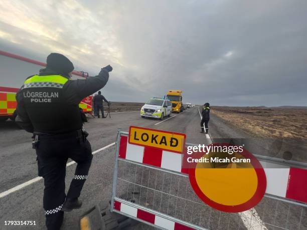 Police direct traffic out of Grindavik on November 14, 2023 in Grindavik, Iceland. For the second day residents were allowed in to quickly collect...