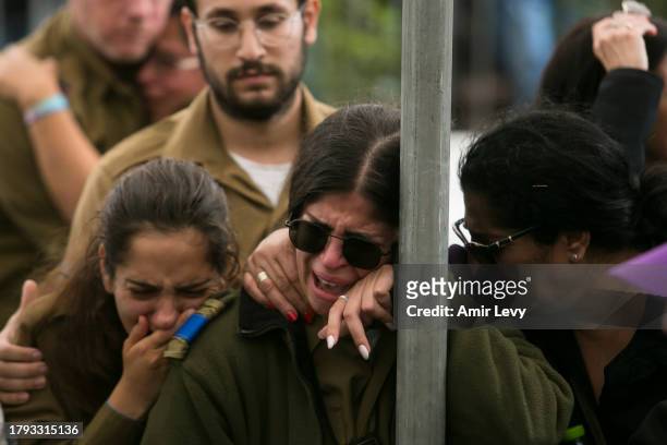 Family and friends mourn during a funeral for Lt. Adir Portugal on November 20, 2023 in Mazkeret Batya, Israel. The Israeli military announced Lt....
