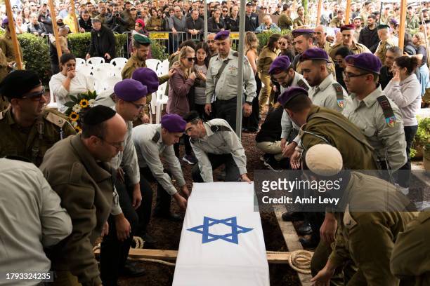 Family and friends mourn during a funeral for Lt. Adir Portugal on November 20, 2023 in Mazkeret Batya, Israel. The Israeli military announced Lt....