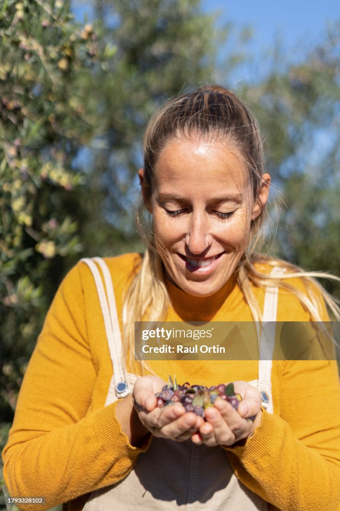 Portrait of woman farmer at olive harvesting.