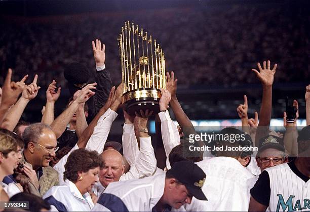 General view of players for the Florida Marlins holding the trophy after the seventh game of the World Series against the Cleveland Indians at Pro...