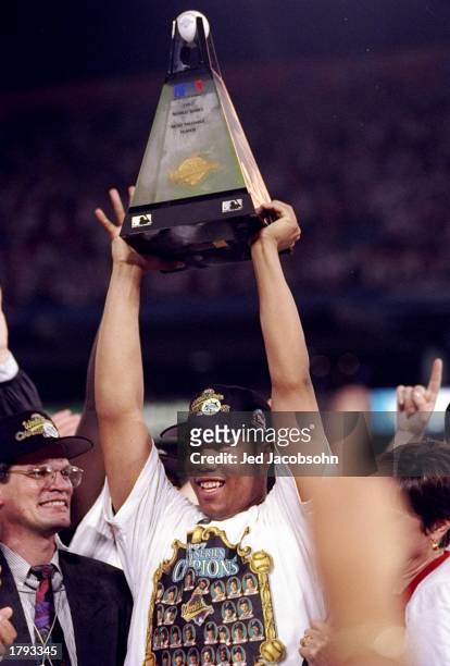 Pitcher Livan Hernandez of the Florida Marlins holds a trophy after the seventh game of the World Series against the Cleveland Indians at Pro Player...