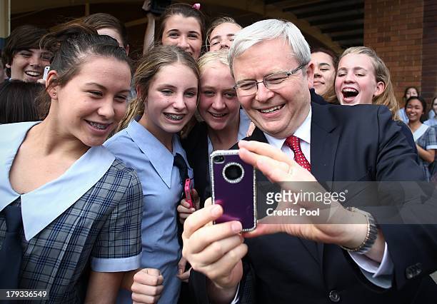Students pose for photographs with Australian Prime Minister, Kevin Rudd at St Columan's College on September 2, 2013 in Caboolture, Australia....