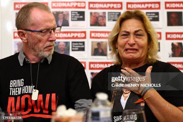Orit Meir , mother of Almog Meir, cries next to Thomas Hand, father of Emily Hand, during a press conference by families of hostages held by...