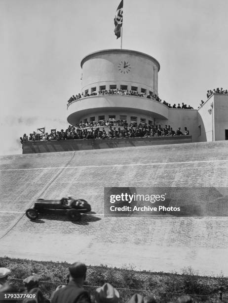 Charles Martin from Great Britain drives the English Racing Automobiles A-Type through the Nordkurve banking below the control tower during the VI...