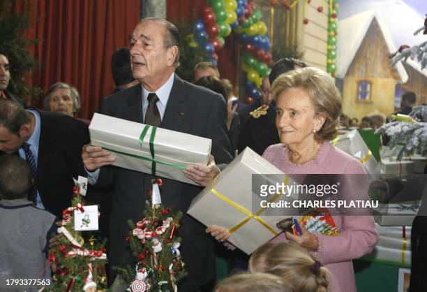 French President Jacques Chirac and his wife Bernadette give presents to their young guests at the traditional Christmas tree party at the Elysee...
