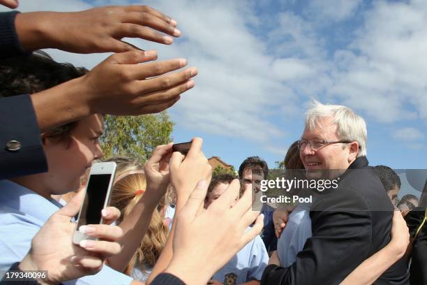 Australian Prime Minister, Kevin Rudd receives a hug from a student on September 2, 2013 in Caboolture, Australia. According to the News Limited...