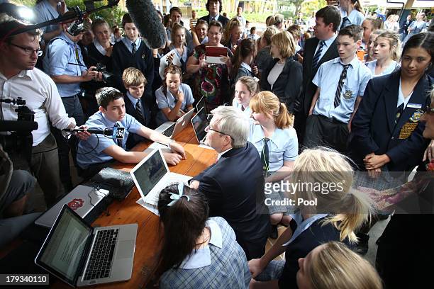 Australian Prime Minister, Kevin Rudd sits with students at St Columban's College on September 2, 2013 in Caboolture, Australia. According to the...