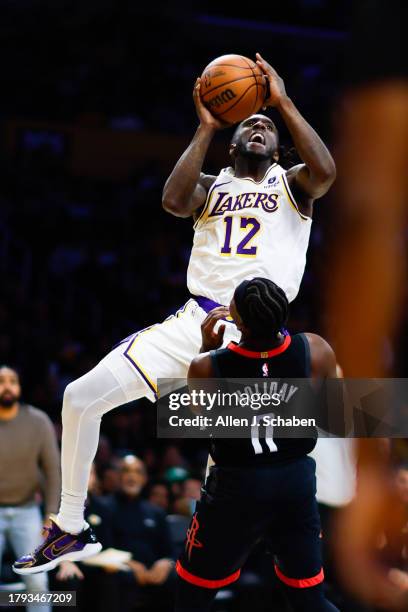 Los Angeles Lakers forward Taurean Prince goes up for a shot while Houston Rockets guard Aaron Holiday defends during the second half at Crypto.com...