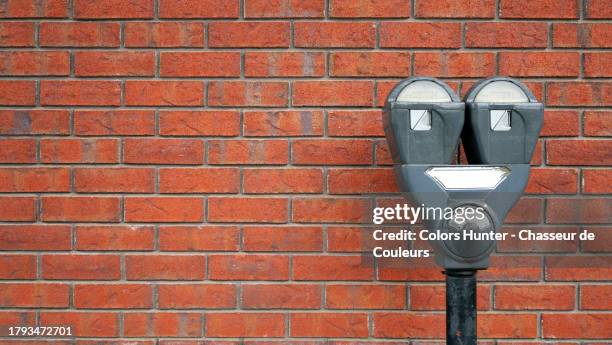 close-up of a parking meter in front of a brick wall in montreal, quebec, canada - penalty fee stock pictures, royalty-free photos & images