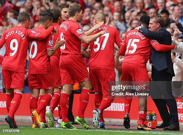 Daniel Sturridge of Liverpool celebrates scoring the opening goal with Manager Brendan Rodgers during the Barclays Premier League match between...