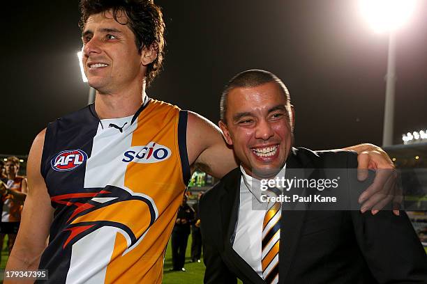 Andrew Embley of the Eagles embraces Daniel Kerr after playing his last game for the club during the round 23 AFL match between the West Coast Eagles...