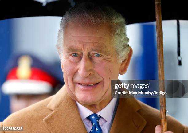 King Charles III shelters under an umbrella as he, to mark his 75th birthday today, officially launches The Coronation Food Project at the South...