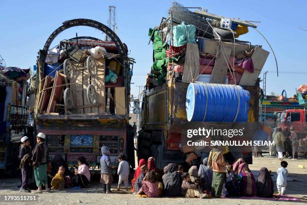 Afghan refugees sit beside their belongings at a registration centre upon their arrival from Pakistan, near the Afghanistan-Pakistan border in the...