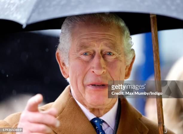 King Charles III shelters under an umbrella as he, to mark his 75th birthday today, officially launches The Coronation Food Project at the South...
