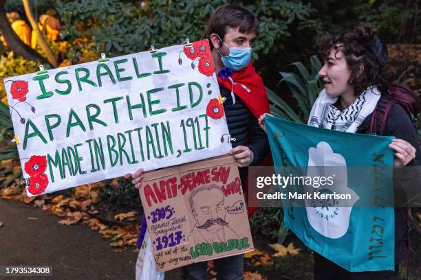 Protesters holding signs and a banner are pictured at the end of a rally in Victoria Embankment Gardens organised by Na'amod UK and attended by...