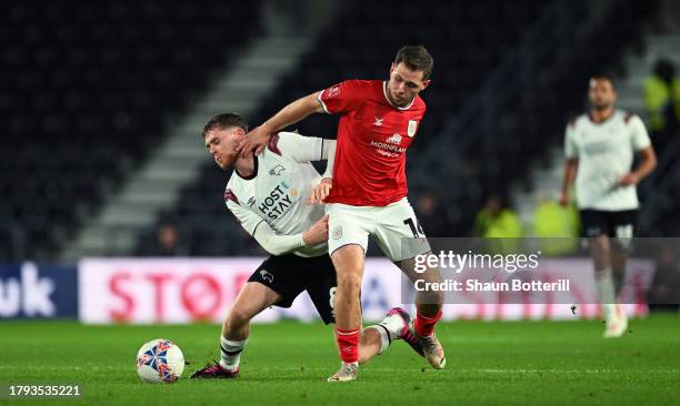 Max Bird of Derby County and Charlie Colkett of Crewe Alexandra battle for the ball during the Emirates FA Cup First Round Replay match between Derby...