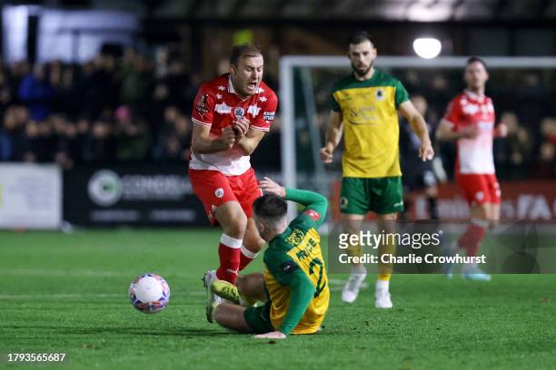 Herbie Kane of Barnsley is challenged by Bobby Price of Horsham during the Emirates FA Cup First Round Replay match between Horsham and Barnsley at...
