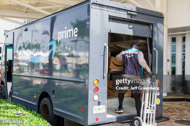 Miami Beach, Florida, Amazon Prime delivery van with driver holding hand truck.