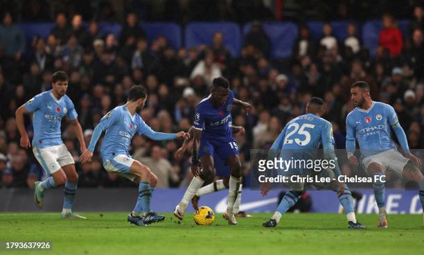 Nicolas Jackson of Chelsea battles with the Manchester City defence during the Premier League match between Chelsea FC and Manchester City at...