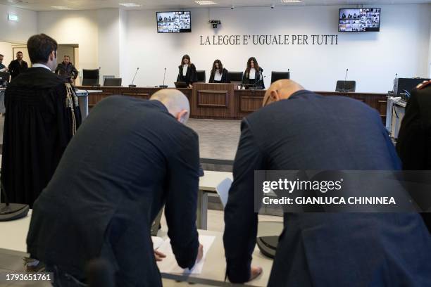 Magistrates stand during the reading of the verdict at the maxi mafia-trial in Lamezia Terme on November 20, 2023 where some 200 people were...