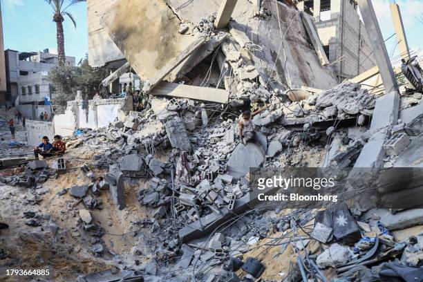 Palestinians amongst the rubble of a building destroyed by an Israeli strike in Khan Younis, Gaza, on Saturday, Nov. 18, 2023. While Israel has...