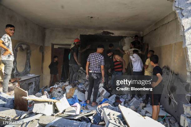 Palestinians search the remains of a home destroyed by an Israeli strike in Khan Younis, Gaza, on Saturday, Nov. 18, 2023. While Israel has...
