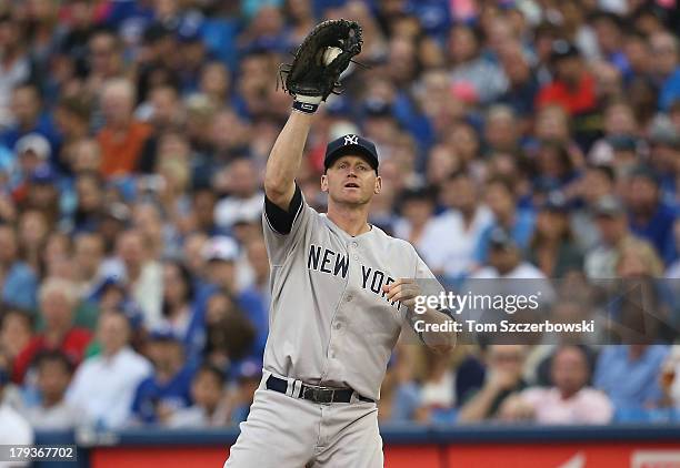 Lyle Overbay of the New York Yankees records the putout at first base to end the first inning during MLB game action against the Toronto Blue Jays on...