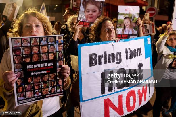 Protesters lift placards during a rally outside the Unicef offices in Tel Aviv on November 20, 2023 to demand the release of Israelis held hostage in...