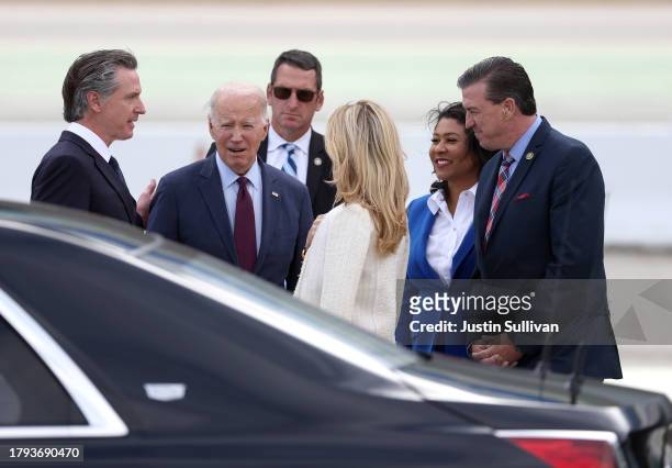 President Joe Biden talks with California Governor Gavin Newson and his wife Jennifer Siebel Newsom after arriving at San Francisco International...