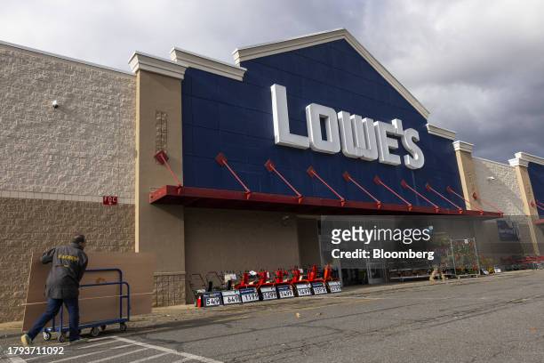 Customer pushes a cart outside a Lowe's store in Glenmont, New York, US, on Tuesday, Nov. 14, 2023. Lowe's Cos. Is expected to release earnings...