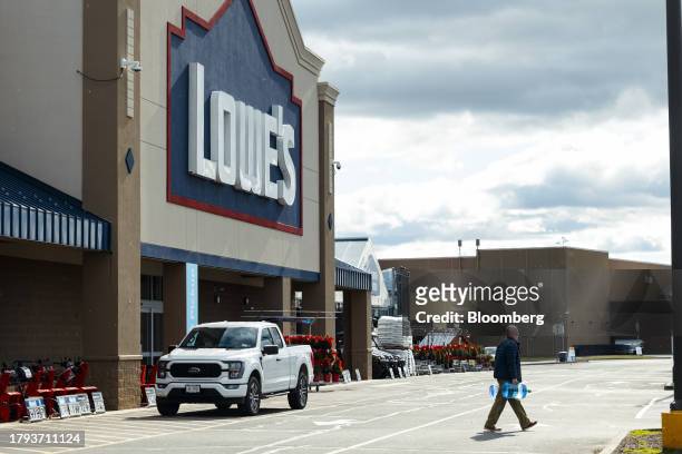 Customer carries water bottles outside a Lowe's store in Hudson, New York, US, on Tuesday, Nov. 14, 2023. Lowe's Cos. Is expected to release earnings...