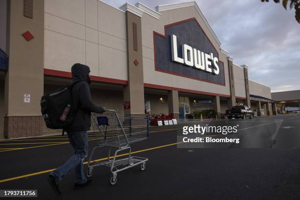 Shopper pushes a cart outside a Lowe's store in Albany, New York, US, on Tuesday, Nov. 14, 2023. Lowe's Cos. Is expected to release earnings figures...