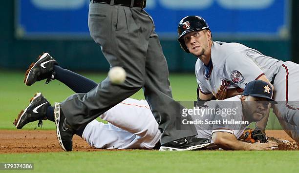 Jose Altuve of the Houston Astros cannot a play at second base in the fourth inning on Clete Thomas of the Minnesota Twins at Minute Maid Park on...