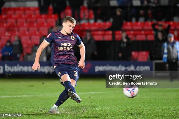 Archie Collins of Peterborough United scores a penalty to win game during the Emirates FA Cup First Round Replay match between Salford City and...