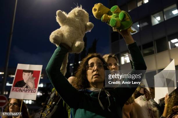 Woman holds teddy bears during a rally outside Tel Aviv's Unicef offices on Novenmber 20, 2023 in Tel Aviv, Israel. Families of hostages and their...