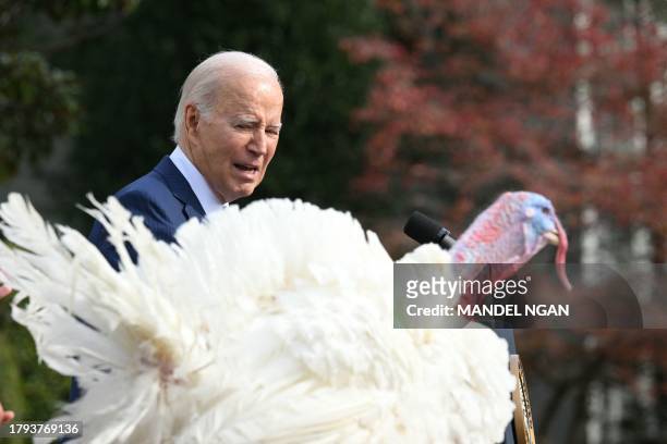 President Joe Biden pardons the national Thanksgiving turkey, Liberty, during a pardoning ceremony at the White House in Washington, DC on November...