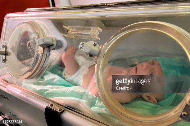 Premature Palestinian baby evacuated from Gaza is pictured inside an ambulance on the Egyptian side of the Rafah border crossing with the Gaza Strip,...