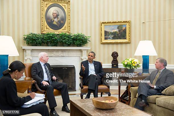 In this handout provided by the White House, U.S. President Barack Obama meets with Senators John McCain and Lindsey Graham , and National Security...