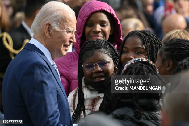 President Joe Biden greets guests as he takes part of the annual Thanksgiving Turkey pardon on the South Lawn of the White House in Washington, DC on...