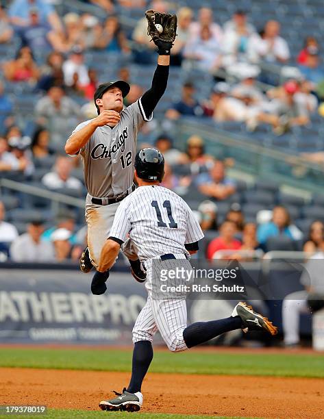 Third baseman Conor Gillaspie of the Chicago White Sox jumps high to catch a deflected ball hit by Derek Jeter of the New York Yankees who beat the...