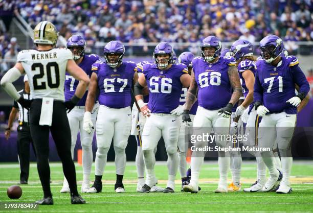 Members of the Minnesota Vikings offensive line stand between plays in the second quarter of the game against the New Orleans Saints at U.S. Bank...