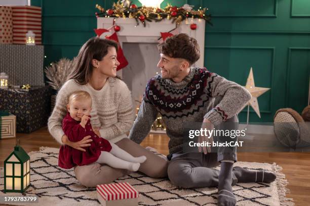 happy family pending time together during christmastime at home - pending stock pictures, royalty-free photos & images