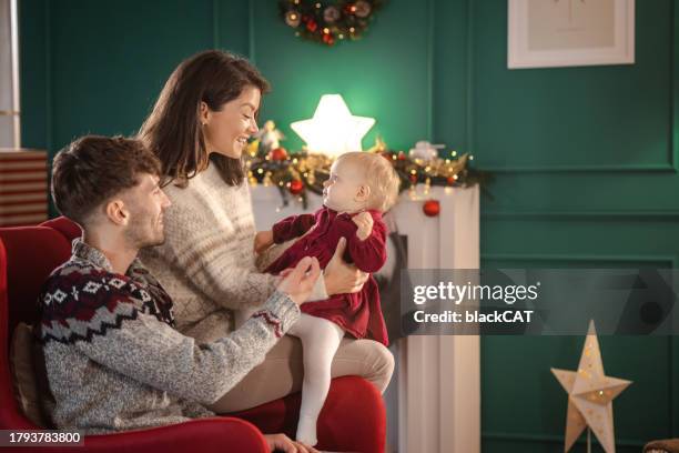 happy family pending time together during christmastime at home - pending stock pictures, royalty-free photos & images