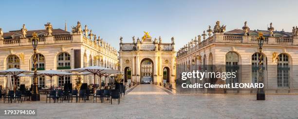 panorama of the triumphal arch arc héré (here arch) at the place stanislas (stanislaw square) with cafe terraces, nancy, meurthe et moselle, lorraine, eastern france. - stanislas stock pictures, royalty-free photos & images