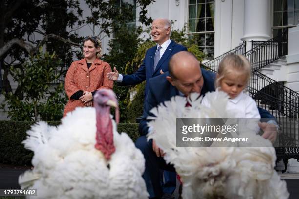 Standing next to his granddaughter Maisy, U.S. President Joe Biden smiles after pardoning National Thanksgiving turkeys Liberty and Bell during a...